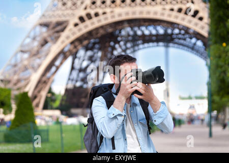 View of a Young attractive tourist taking pictures in Paris, France Stock Photo