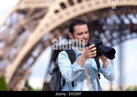 View of a Young attractive tourist taking pictures in Paris, France Stock Photo