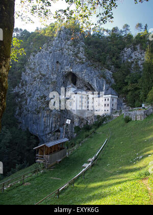 View of Predjama castle, a renaissance castle built in a cave, with a field for medieval tournaments, near Postojna. Slovenia. Stock Photo