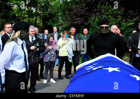 Londonderry, Northern Ireland, UK. 18 July, 2015. Funeral of prominent Irish Republican, Peggy O’Hara. Members of the Irish National Liberation Army (INLA) accompany the funeral of 86-year-old Peggy O’Hara, a prominent Irish Republican and mother of Derry INLA man Patsy O’Hara who died on hunger strike in Long Kesh in 1981. The remains of Mrs O’Hara were buried in the City Cemetery, in Derry, following a requiem mass at St Columba’s Church. Credit:  George Sweeney/Alamy Live News Stock Photo
