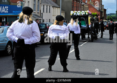 Londonderry, Northern Ireland, UK. 18 July, 2015. Funeral of prominent Irish Republican, Peggy O’Hara. Members of the Irish National Liberation Army (INLA) accompany the funeral of 86-year-old Peggy O’Hara, a prominent Irish Republican and mother of Derry INLA man Patsy O’Hara who died on hunger strike in Long Kesh in 1981. The remains of Mrs O’Hara were buried in the City Cemetery, in Derry, following a requiem mass at St Columba’s Church. Credit:  George Sweeney/Alamy Live News Stock Photo