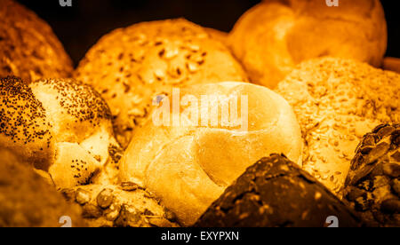 Assortment of golden loafs of bread and bread rolls Stock Photo