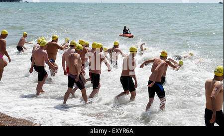 Brighton UK Saturday 18th July 2015 - Competitors in the mens race set off in the annual Brighton Pier to Pier sea swim race today in hot weather Credit:  Simon Dack/Alamy Live News Stock Photo