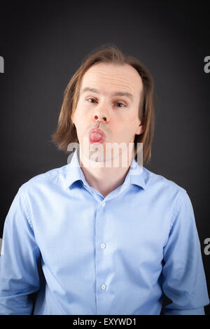 Handsome man doing different expressions in different sets of clothes: making a face Stock Photo