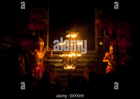 Balinese traditional dancers on stage with decorative firelights during kecak and fire dance show in Ubud, Gianyar, Bali, Indonesia. Stock Photo