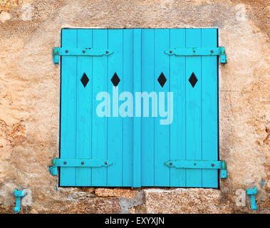 azure shutters in an old wall Stock Photo