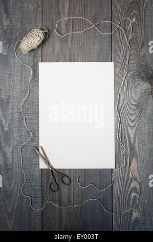 Skein and scissors on the textured wooden table Stock Photo