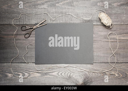 Skein and scissors on the textured wooden table Stock Photo