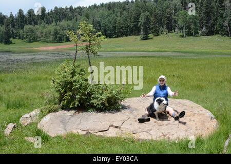 My sister and her dog on giant boulder Gregorio Lake New Mexico - USA Stock Photo