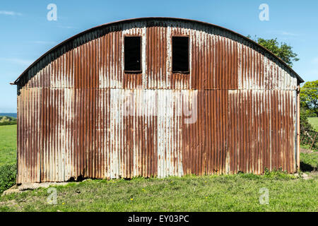 A rusting Tin corrugated hay barn in the countryside Stock Photo