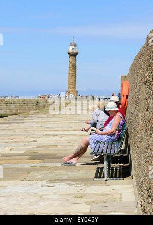 Relaxing on East Pier Whitby Stock Photo
