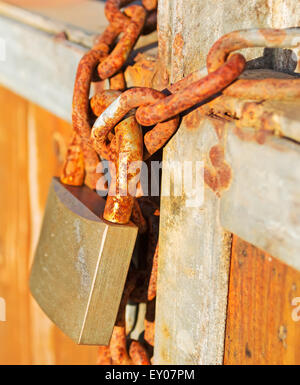 rusty padlock on a wooden gate Stock Photo