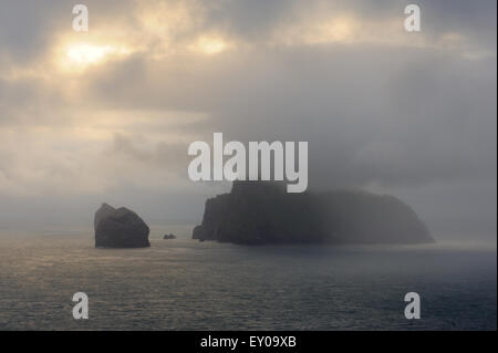 The island of Boreray and Stac Lee and Stac an Armin, all part of the St Kilda archipelago, loom out of the early morning mist. Stock Photo
