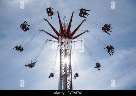 People enjoying swing ride Stock Photo