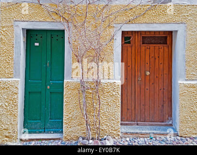 two old doors in a beige wall Stock Photo