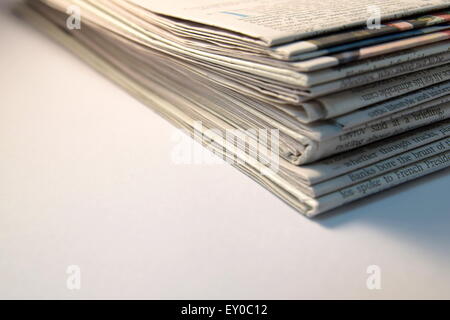 Close-up Stack of newspapers on white background Stock Photo