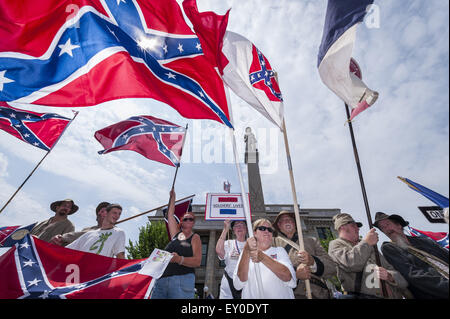 Graham, North Carolina, USA. 18th July, 2015. Rally participants, some wearing confederate symbols and waving confederate flags, gathered at the historic Alamance County courthouse in support of the Confederate monument during the ''Rally For Our Monument''Â in downtown Graham, N.C. on July 18, 2015. The event, which drew as many as 1500 people, was created in response to the controversy surrounding the Confederate battle flag in South Carolina and Concerned Citizens of Alamance County's intent on requesting the removal of the monument. Rally participants, some wearing confederate symbols an Stock Photo