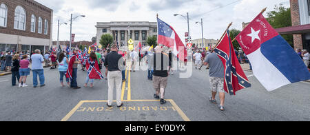 Graham, North Carolina, USA. 18th July, 2015. Rally participants, some wearing confederate symbols and waving confederate flags, gathered at the historic Alamance County courthouse in support of the Confederate monument during the ''Rally For Our Monument''Â in downtown Graham, N.C. on July 18, 2015. The event, which drew as many as 1500 people, was created in response to the controversy surrounding the Confederate battle flag in South Carolina and Concerned Citizens of Alamance County's intent on requesting the removal of the monument. Rally participants, some wearing confederate symbols an Stock Photo