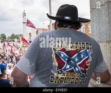 Graham, North Carolina, USA. 18th July, 2015. Rally participants, some wearing confederate symbols and waving confederate flags, gathered at the historic Alamance County courthouse in support of the Confederate monument during the ''Rally For Our Monument''Â in downtown Graham, N.C. on July 18, 2015. The event, which drew as many as 1500 people, was created in response to the controversy surrounding the Confederate battle flag in South Carolina and Concerned Citizens of Alamance County's intent on requesting the removal of the monument. Rally participants, some wearing confederate symbols an Stock Photo