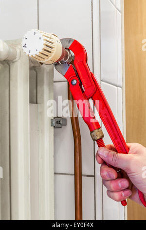 an small repair to the radiator with a pipe wrench Stock Photo