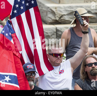 Graham, North Carolina, USA. 18th July, 2015. Rally participant holds a Bible and an American Flag as 1500 people gathered at the historic Alamance County courthouse in support of the Confederate monument during the 'Rally For Our Monument' in downtown Graham. © Sean Meyers/ZUMA Wire/Alamy Live News Stock Photo