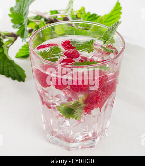 Cold drink with raspberries, ice and fresh mint. Selective focus Stock Photo