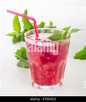 Summer cold drink with raspberries, ice and mint leaves. Selective focus Stock Photo
