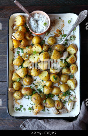 baked young potatoes and chopped greens, top view Stock Photo
