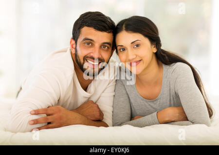 beautiful young Indian married couple lying on bed Stock Photo