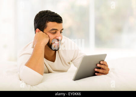 modern young Indian man using tablet computer at home Stock Photo