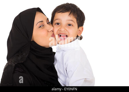 beautiful young Muslim mother kissing her son on white background Stock Photo