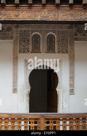 Archway with richly carved detailing, Ben Youssef Madrasa historical Islamic college in Marrakesh, Morocco Stock Photo