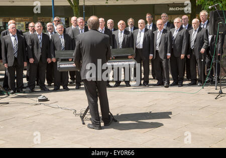 Male voice choir performing in Castle Square, Swansea, West Glamorgan, South Wales, UK Stock Photo