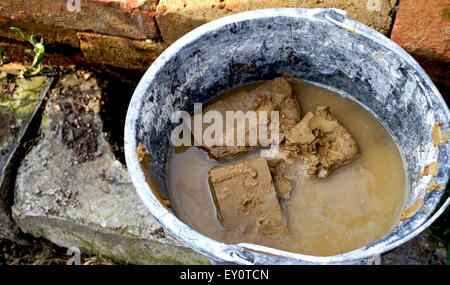 clay brick in water bucket Stock Photo