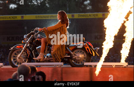Aspach, Germany. 18th July, 2015. Singer Andrea Berg arrives on a motorcycle on stage as she performs during her concert tour 'Heimspiel' (lit. home match) in Aspach, Germany, 18 July 2015. Credit:  dpa picture alliance/Alamy Live News Stock Photo