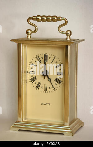 Table clock showing 5 o'clock. Stock Photo