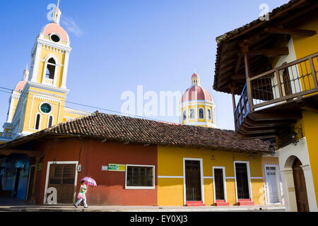 Local woman with her baby walking on the streets of Granada old town, Nicaragua Stock Photo