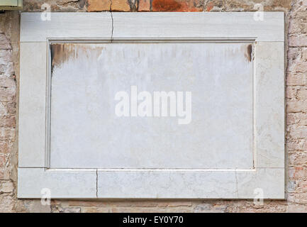 marble frame in a brick wall Stock Photo