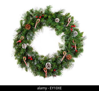 Christmas wreath isolated on white background. Decorated with candy canes, cones and red berries. Stock Photo