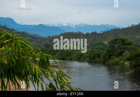 View of the snow-capped Sierra Nevada de Santa Marta Caribbean mountains on Palomino River in Colombia, South America. Stock Photo