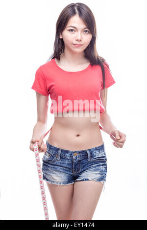 Chinese woman measuring waist with tape Stock Photo