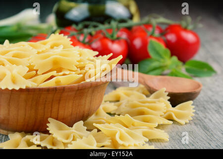Raw farfalle pasta in bowl on the table Stock Photo
