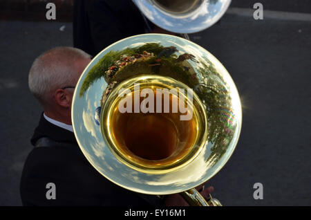 Tolpuddle, Dorset, UK. 19th July, 2015. A brass band marches through the street in the festival procession and a man shows us his tuba at Tolpuddle, Dorset, UK on Sunday 19th July 2015. Every July the village of Tolpuddle in Dorset, UK, hold this festival in memory of the Tolpuddle Martyrs. The Martyrs were six farm workers who lived and worked in the village of Tolpuddle. They were arrested on 24 February 1834 on the charge of making an illegal oath. The actual offence was in forming a trade union to address their poor working conditions. Credit:  Grahame Howard/17�Թ����� Live News Stock Photo