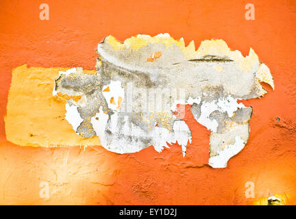 Peeling orange paint on a stone wall, as a background Stock Photo