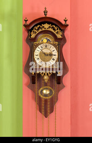 old retro clock on the color wall Stock Photo