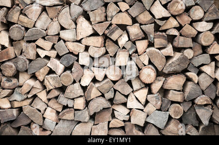 Cut and split firewood stacked in heap Stock Photo