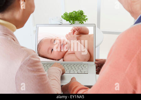 Senior couple looking at the laptop together, Stock Photo