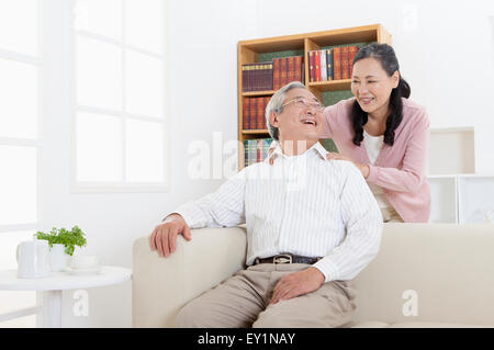 Senior woman massaging for the senior man on the shoulder, Stock Photo