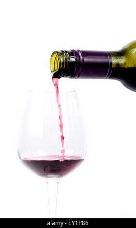 Red wine pouring into a glass on white background Stock Photo