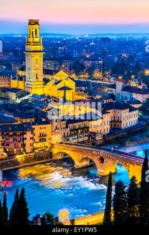 Verona, Italy. Twilight view of medieval city, Ponte Pietra and Cathedral Duomo di Verona tower. Stock Photo